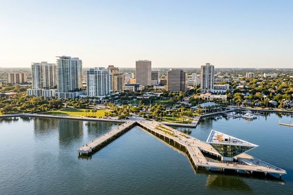 Aerial view of downtown St. Petersburg FL real estate, featuring the St. Pete Pier, waterfront skyline, and Tampa Bay.